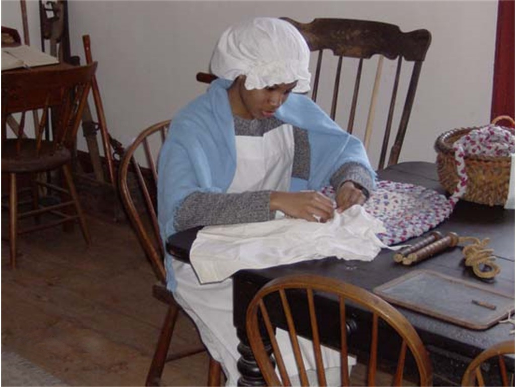 Volunteer Kirsten working on fabric in the Cottage